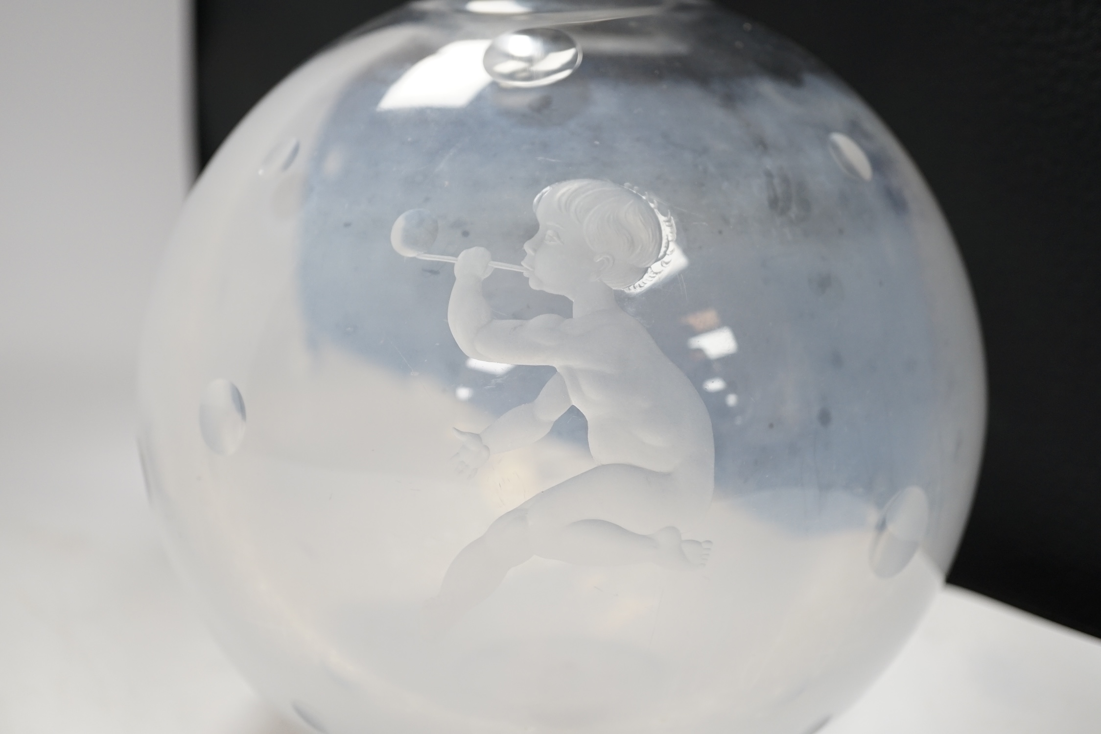 An Orrefors globular glass vase, engraved with a boy blowing bubbles, attributed to Vicke Lindstrand, indistinctly signed on worn base, 19cm high